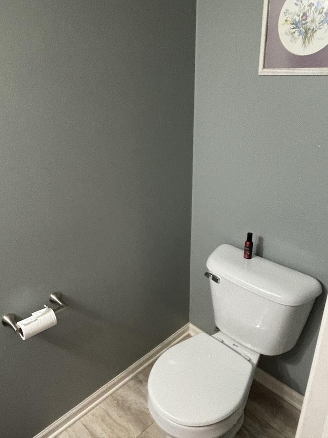 bathroom with hardwood / wood-style floors and toilet