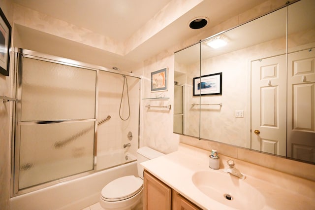 full bathroom featuring enclosed tub / shower combo, vanity, and toilet