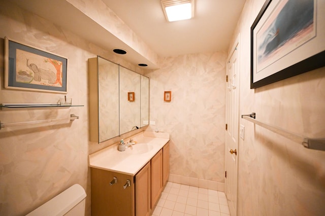 bathroom with tile patterned flooring, vanity, and toilet