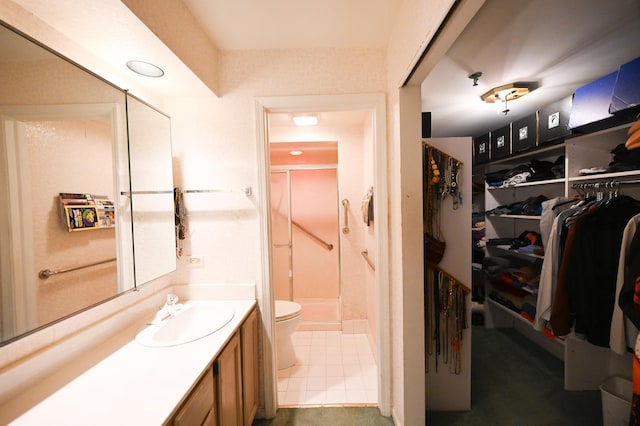 bathroom featuring walk in shower, vanity, and toilet