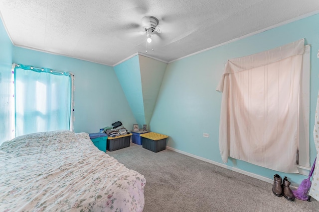 bedroom with lofted ceiling, a textured ceiling, ceiling fan, and carpet flooring