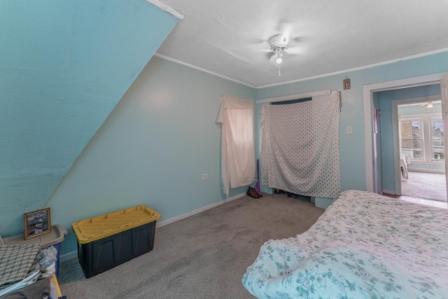 bedroom featuring ceiling fan, ornamental molding, and carpet floors