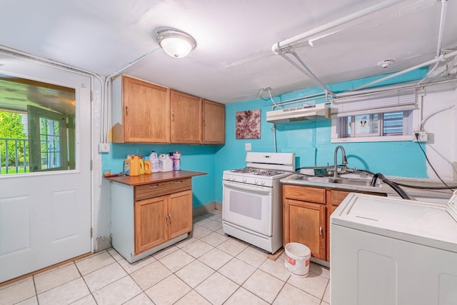 kitchen featuring washer and dryer, sink, and gas range gas stove