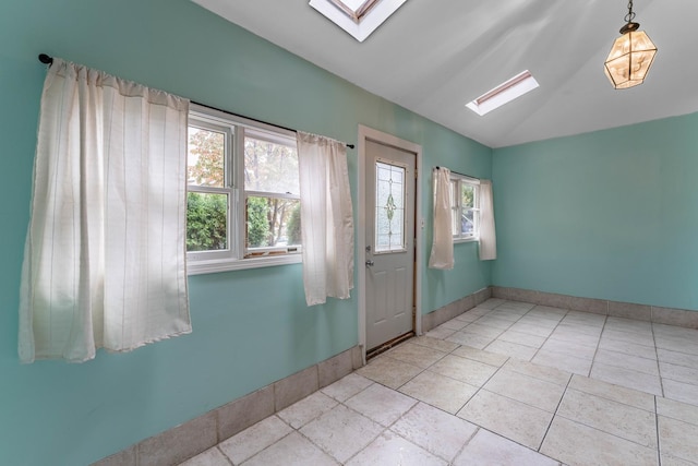 interior space featuring lofted ceiling with skylight