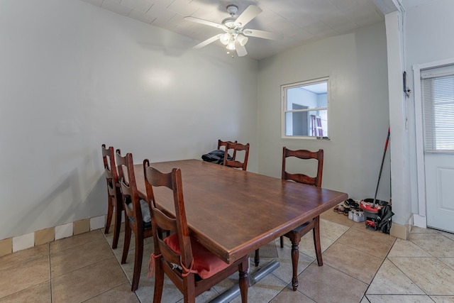 tiled dining area with a healthy amount of sunlight and ceiling fan