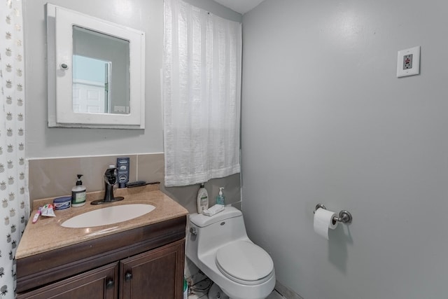 bathroom featuring vanity and toilet