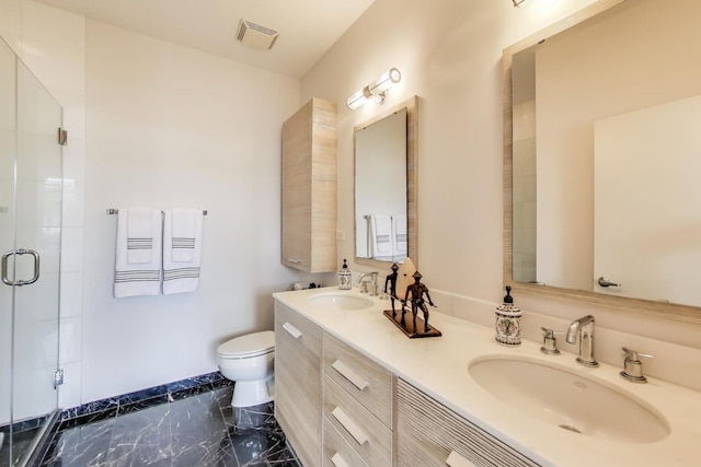 bathroom with marble finish floor, a sink, toilet, and a shower stall