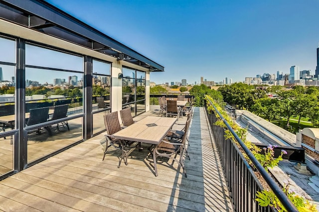 wooden deck featuring a view of city and outdoor dining area