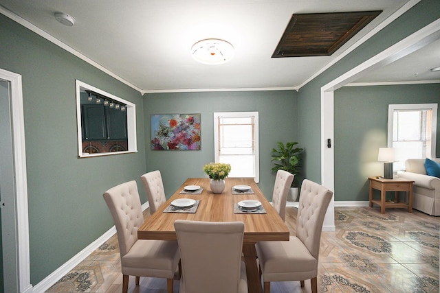 dining space featuring crown molding