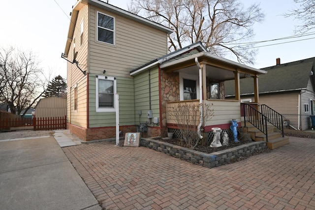 rear view of house with covered porch and a patio area