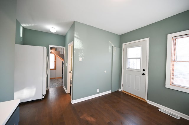 entrance foyer with dark hardwood / wood-style floors