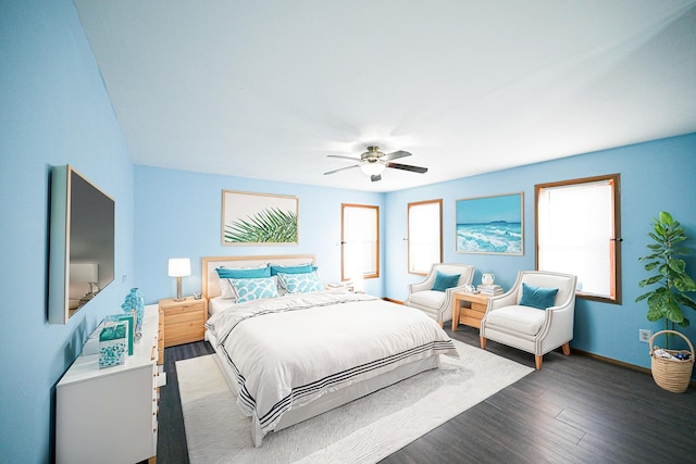 bedroom with dark hardwood / wood-style floors and ceiling fan