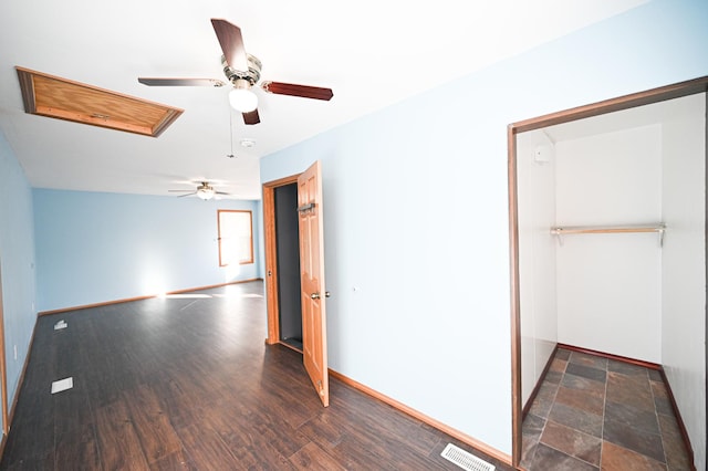 unfurnished bedroom with ceiling fan, dark hardwood / wood-style flooring, and a closet