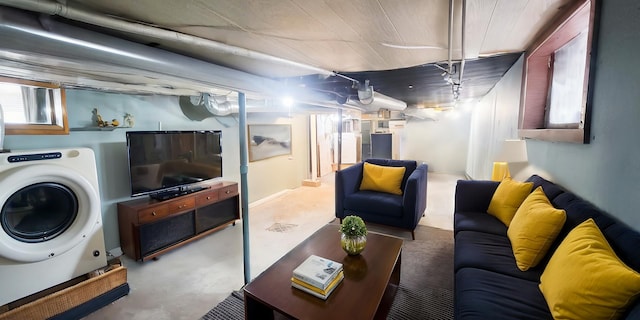 living room with washer / clothes dryer and concrete flooring