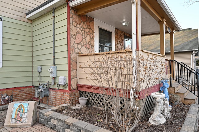 view of side of property featuring covered porch