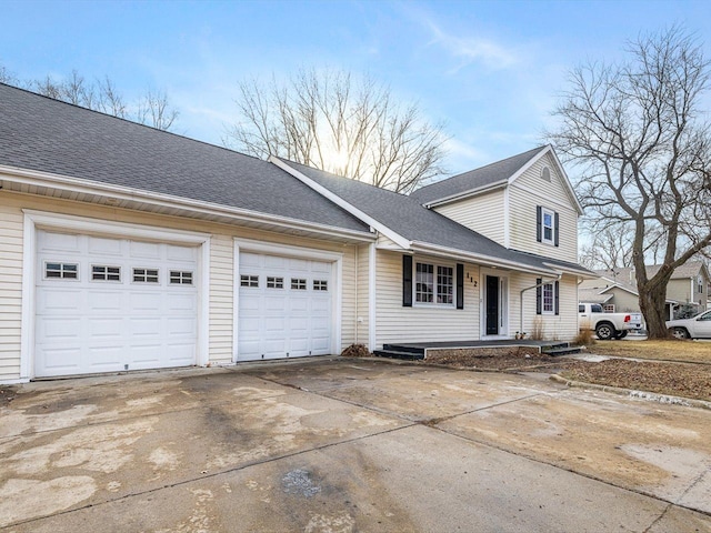 view of property exterior featuring a garage, driveway, and roof with shingles