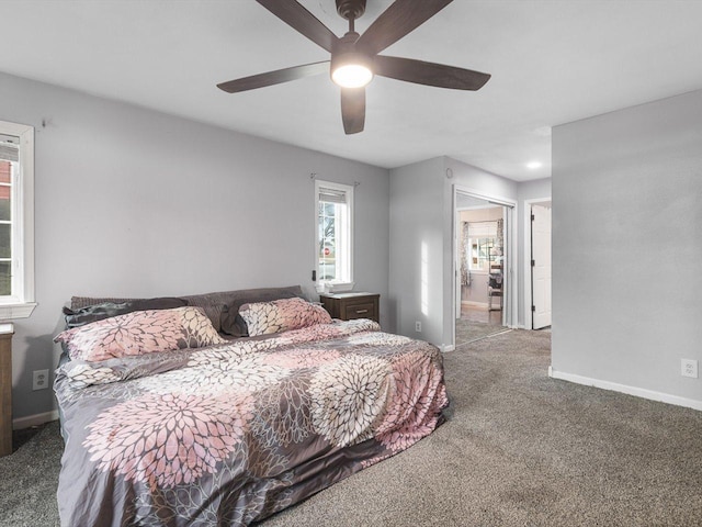 bedroom with carpet flooring, baseboards, connected bathroom, and ceiling fan