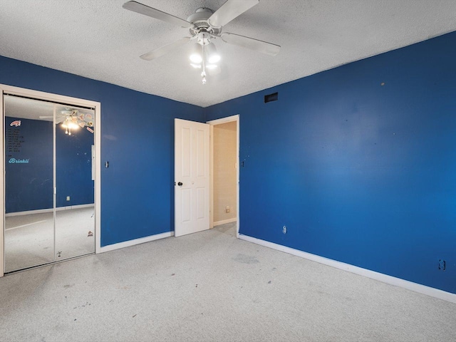 unfurnished bedroom with baseboards, carpet, visible vents, and a textured ceiling