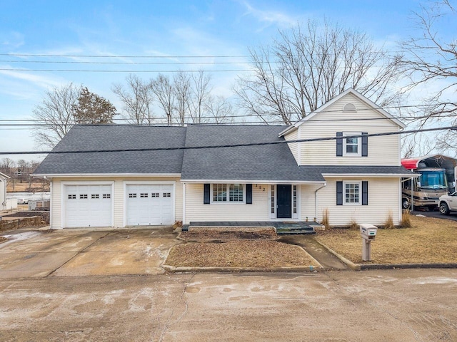 traditional home with driveway, roof with shingles, and an attached garage