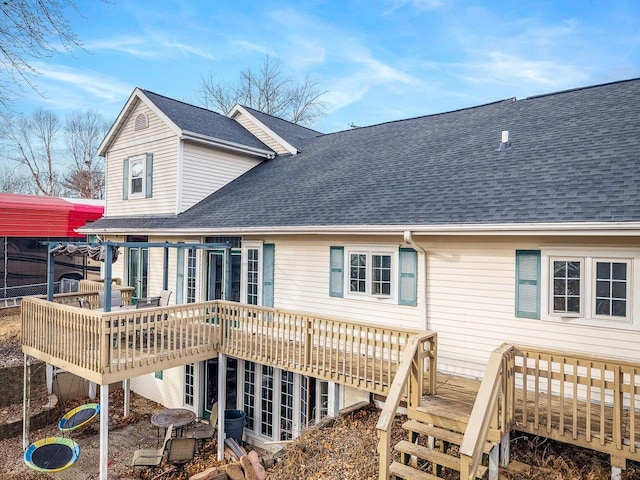 back of house with stairway, a shingled roof, and a deck