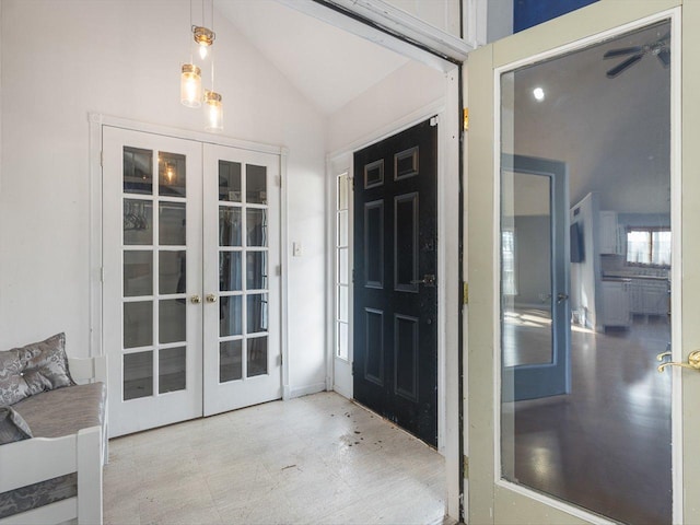 interior space featuring tile patterned floors, french doors, and lofted ceiling