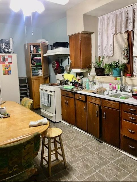 kitchen with sink and white appliances