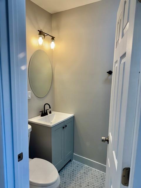 bathroom with vanity, tile patterned flooring, and toilet