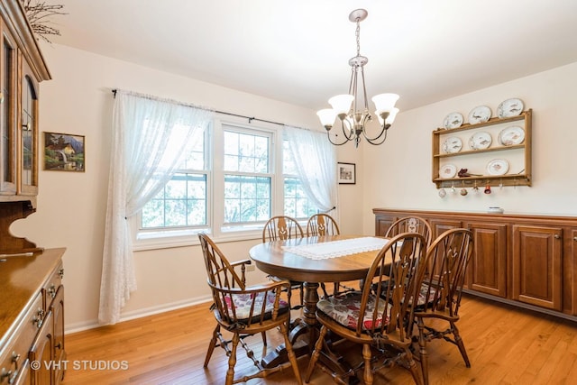 dining area featuring a chandelier and light wood-type flooring