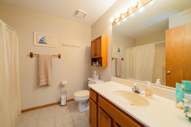 bathroom with toilet, vanity, baseboards, and tile patterned floors