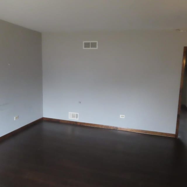 unfurnished room with wood-type flooring