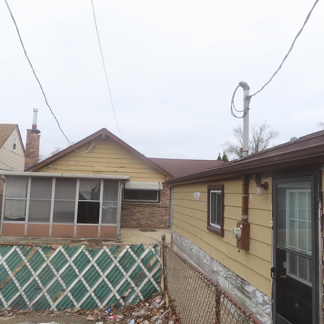 view of side of property with a sunroom