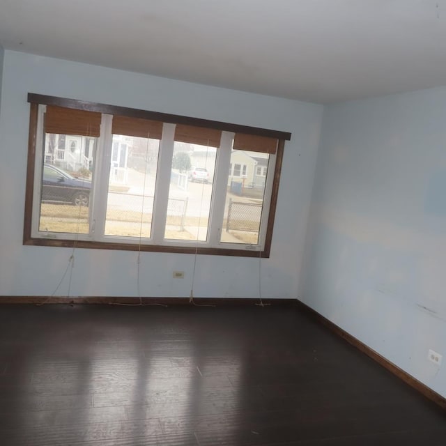 unfurnished room with dark hardwood / wood-style floors