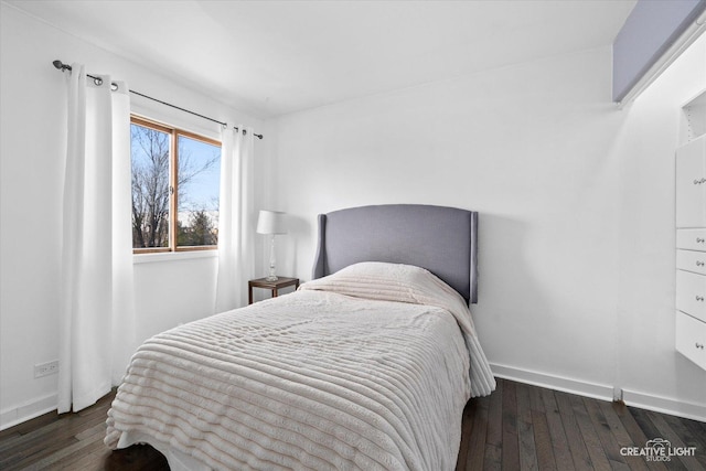 bedroom featuring dark wood finished floors and baseboards