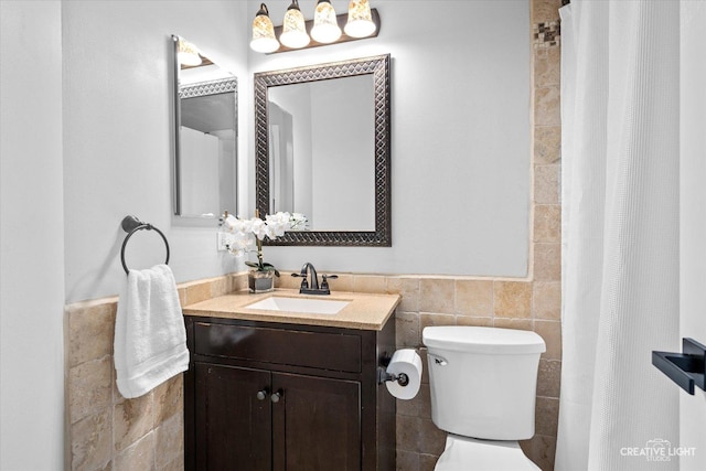 bathroom featuring vanity, tile walls, toilet, and a shower with curtain