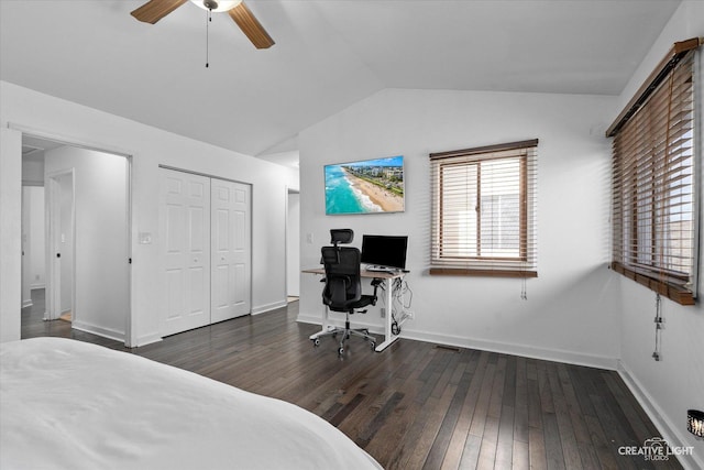 bedroom featuring baseboards, ceiling fan, vaulted ceiling, a closet, and wood-type flooring