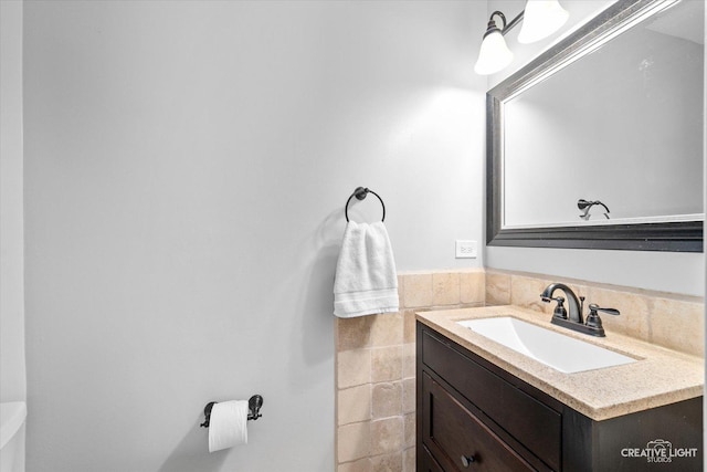 bathroom with vanity and tile walls