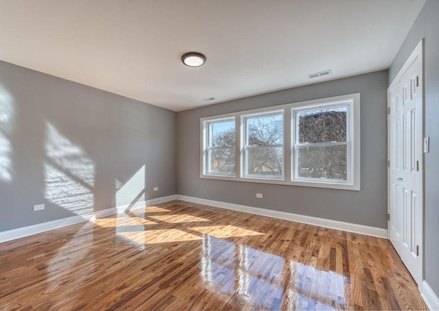 empty room with hardwood / wood-style floors