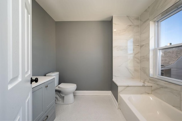 bathroom featuring vanity, a bathtub, and toilet