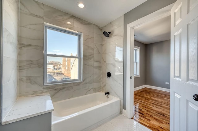 bathroom featuring hardwood / wood-style flooring and tiled shower / bath