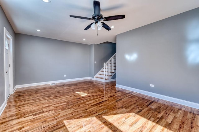 spare room with ceiling fan and light wood-type flooring