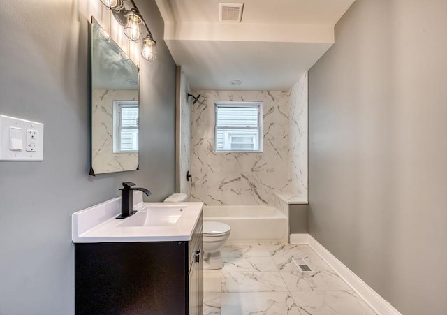 full bathroom with vanity, tiled shower / bath, toilet, and a healthy amount of sunlight