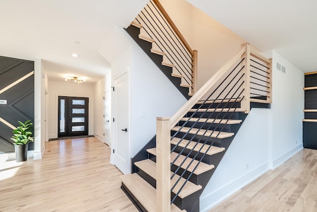 stairway with hardwood / wood-style floors