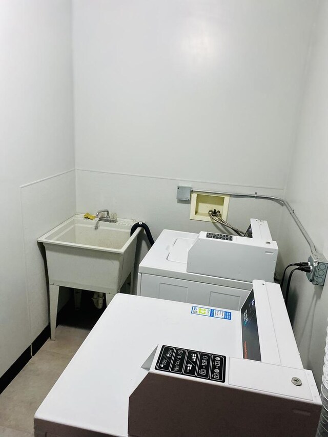 laundry room featuring sink and washing machine and clothes dryer