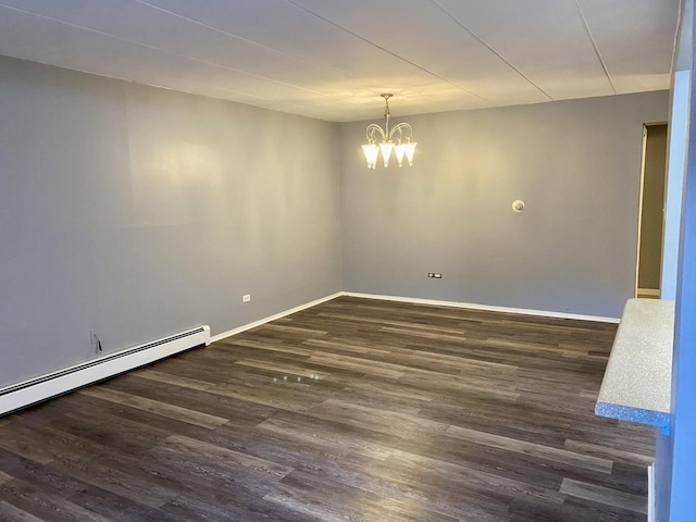 empty room with baseboard heating, dark hardwood / wood-style flooring, and a notable chandelier