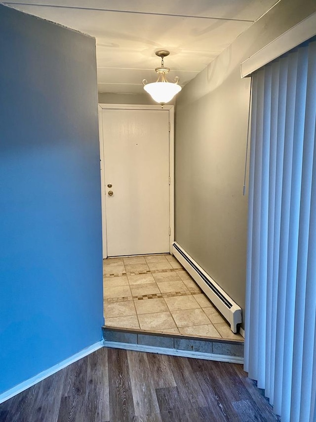 doorway with baseboard heating and wood-type flooring