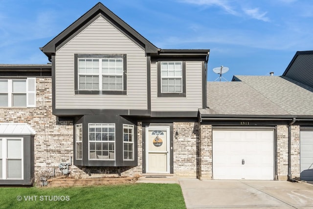 townhome / multi-family property featuring a garage