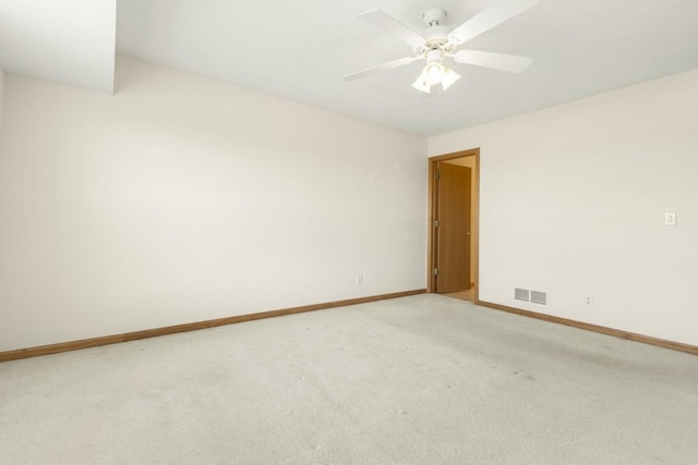 carpeted empty room featuring ceiling fan