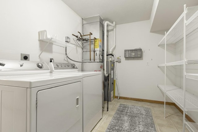 laundry room with light tile patterned flooring and washer and dryer