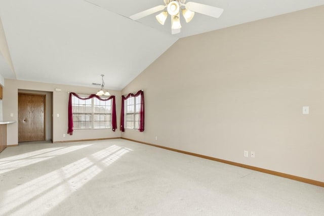 spare room with high vaulted ceiling, light carpet, and ceiling fan