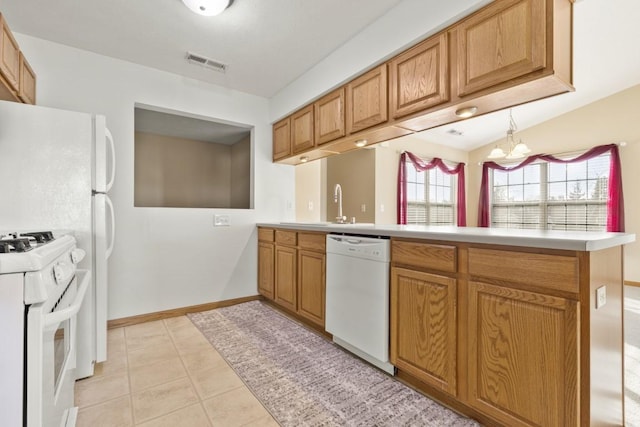 kitchen with a notable chandelier, white appliances, kitchen peninsula, and light tile patterned floors